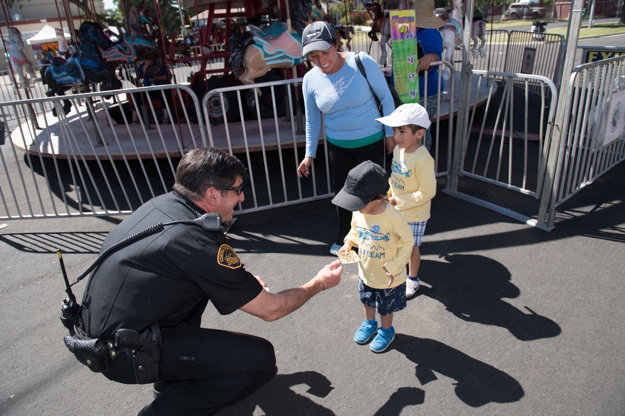 Photo of Officer interacting with family