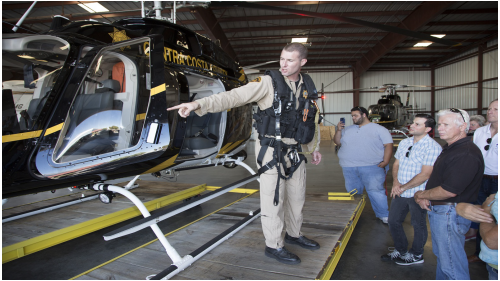 Photo of people in front of a landed helicopter